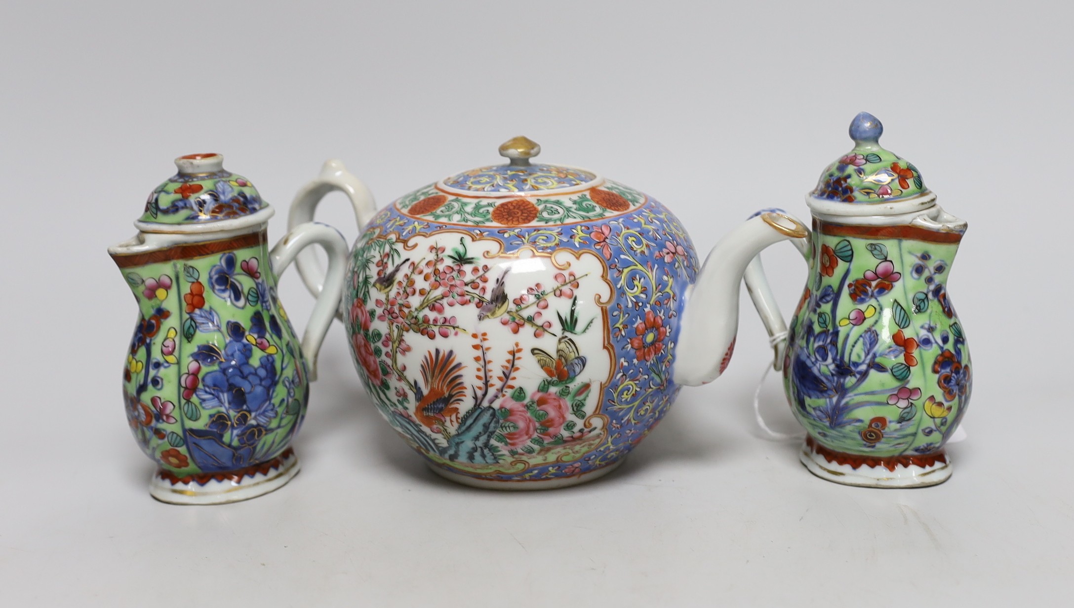 Two Chinese Kangxi clobbered jugs and covers, and a 19th century famille rose teapot, 13cms high